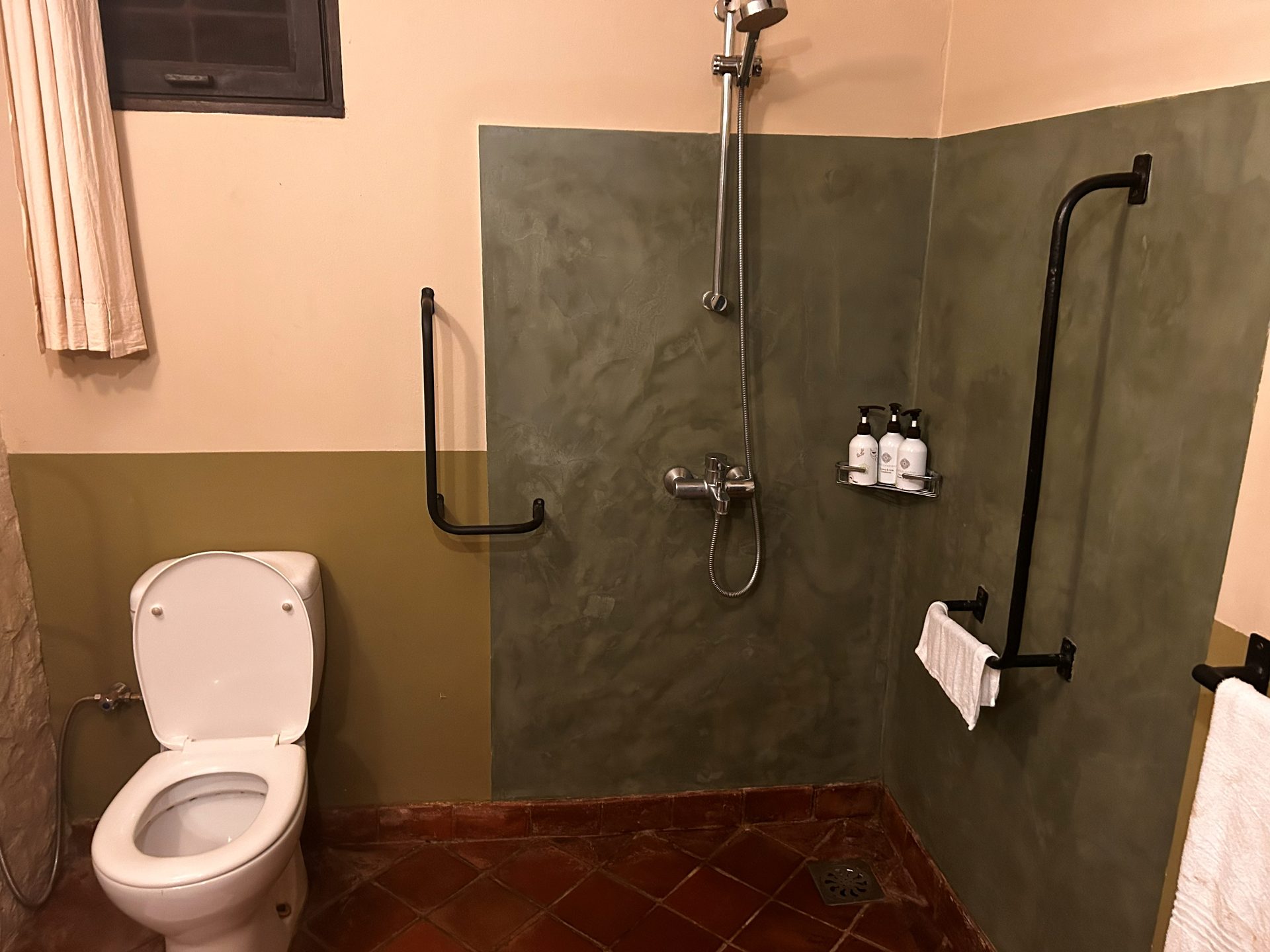 Rivertrees bathroom — polished concrete shower with terracotta tile floor